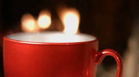 Warm mug of hot coffee by the fireplace Stock Footage 61842400