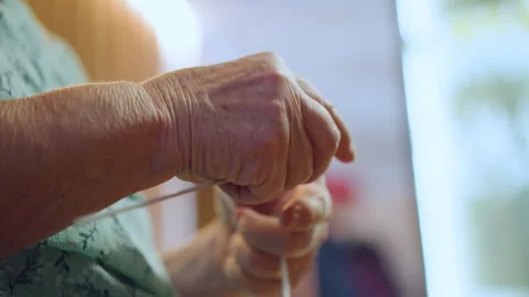 Warm needle action binds generations through careful textile art. Intimate Stock Footage 332277759