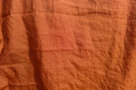 Warm orange fabric texture with soft folds and gentle sheen Stock Photos