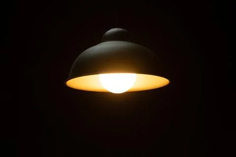Warm orange LED lamp in the ceiling on a dark background Stock Photos