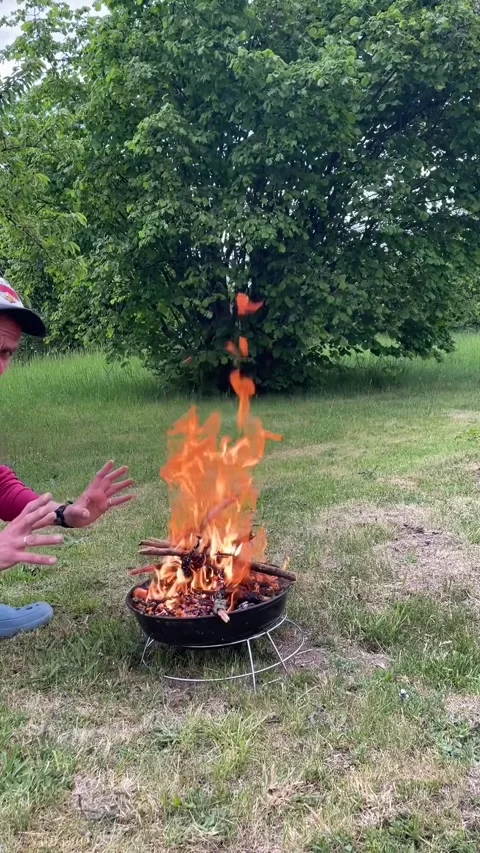 Warm outdoor gathering. Bright flames flicker under evening sky Stock Footage 335359088