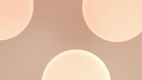 Warm peach-toned seamless loop background with soft glowing circles. 4K. Video stock 305344729