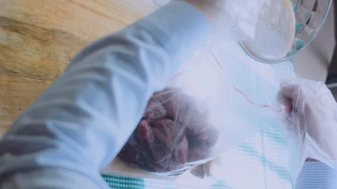 Warm plated dinner: placing steak cubes into a clear marinade bag Stock Footage 342181308