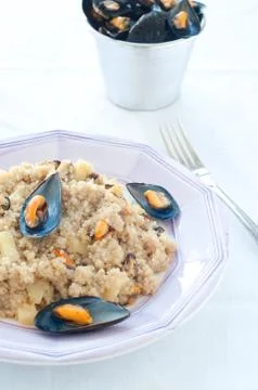 Warm quinoa salad with mussels, tomatoes and potatoes Stock Photos