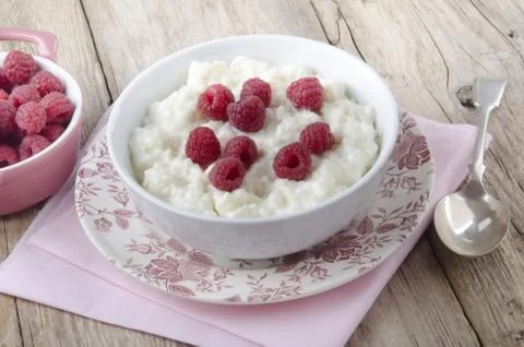 Warm rice pudding with raspberry Stock Photos