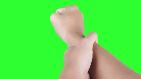 Warm up by rotating your wrists against a green screen background Stock Footage 293601383