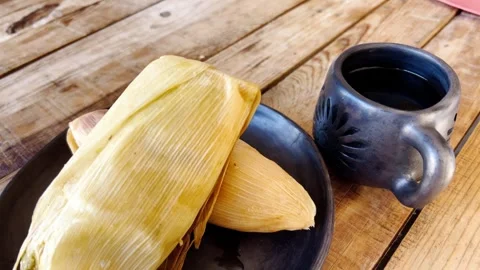 Warm Rustic Breakfast: Tamales and Coffee on a Wooden Table Stock Footage 296142050