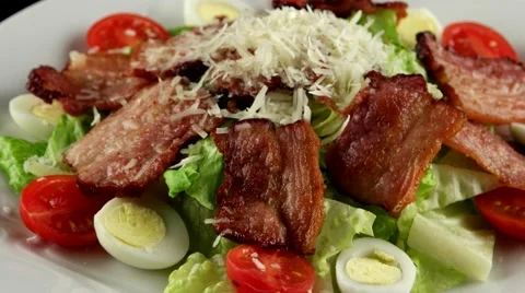 Warm salad with bacon, quail eggs, and Parmesan cheese, loop Stock Footage 61710182