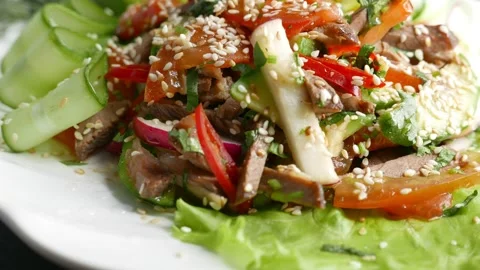 Warm salad with meat, vegetables and sesame Stock Footage 165663904