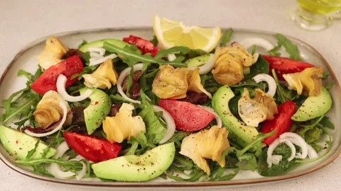 Warm salad with rapans (snails), tomatoes, avocado, arugula, olives, onions. Stock Footage 279565998