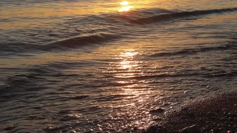 Warm sandy sea shore as waves gently roll in Stock Footage 318594608