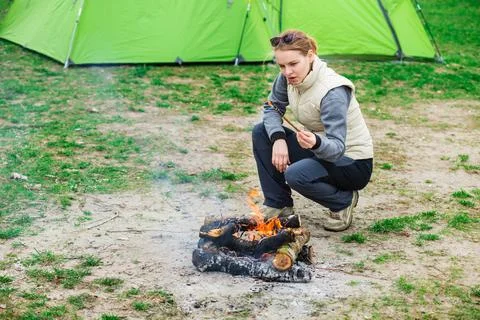 Warm up sitting by the campfire Фото