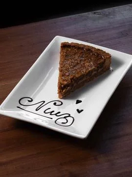 Warm slice of cake rests on elegant white plate Stock Photos