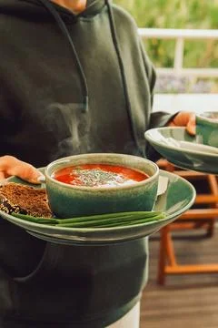Warm soup served with bread and green onions at  casual dining setting during Foto stock