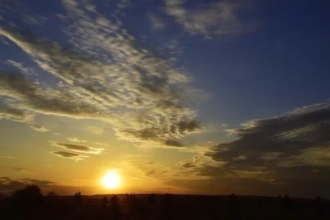 Warm spring sunset in the vastness of the Perm Territory in the foothills of  Stock Photos