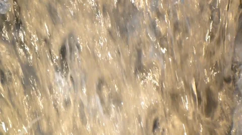 Warm spring water splashes and ripples across the rocks in slow motion Video stock 38354983