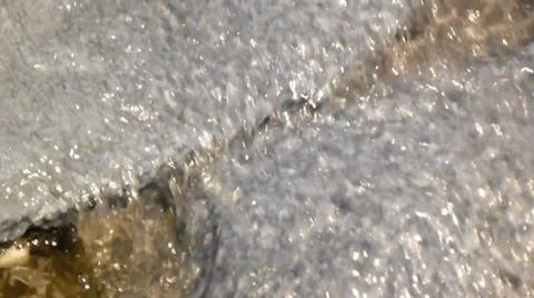 Warm spring water splashes and ripples across the rocks Video stock 38356149