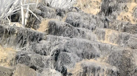 Warm Spring Water splashes and cascades down the rocks Video stock 38365899