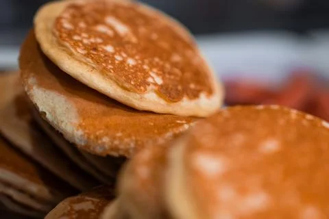Warm stack of golden brown pancakes in soft indoor morning light Stock Photos