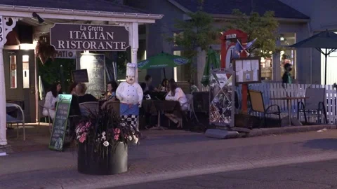 Warm summer night with people walking and restaurant patios open in new normal 動画素材 155585555