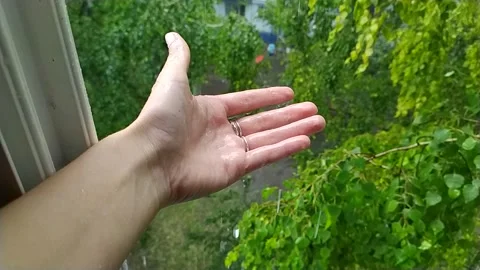 Warm summer rain flows down your hand Stock Footage 135586545