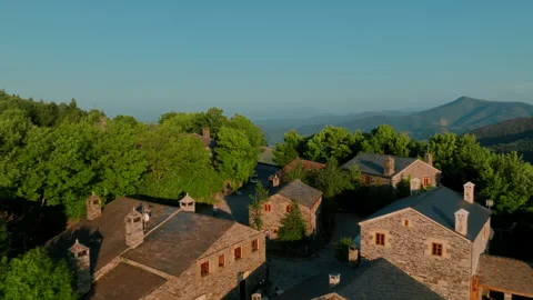 Warm, sun-drenched aerial perspective of a charming, traditional stone village 库存影片 336287158