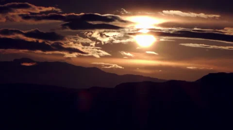 Warm sun rises over the mountain through the clouds Stock Footage 39240344
