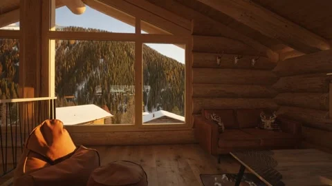 Warm sunlight filling a rustic log cabin living room with a view of a snowy Stock Footage 335786197