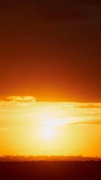 The warm sunlight illuminated the clouds in the background of the sunset sk.. Stock Photos