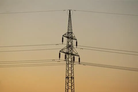 Warm sunlight over structures with layered cables and symmetrical design Stock Photos