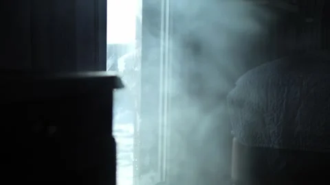 Warm sunlight penetrating window, dramatic shadows highlighting smoke wafting Stock Footage 300665678