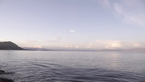 Warm sunset clouds over gentle sea landscape in Corfu Greece Stock Footage 96723025