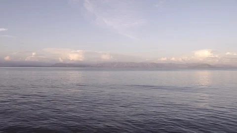 Warm sunset clouds over gentle sea landscape in Corfu Greece Stock Footage 96723119