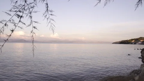 Warm sunset clouds over gentle sea landscape in Corfu Greece Stock Footage 96723156