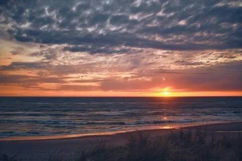 Warm sunset at the coast Stock Photos