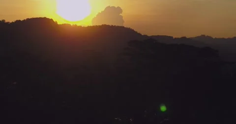Warm Sunset Glow Over Dense Jungle Forest with Atmospheric Haze Stock Footage 332267665