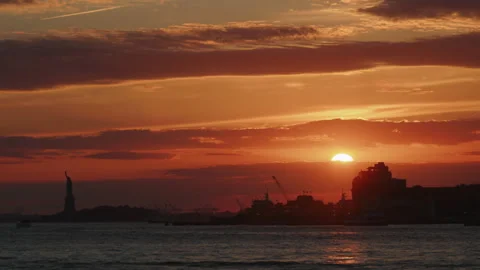 Warm sunset glow over New York City, New York with layered clouds across the Stock-Footage 324623916