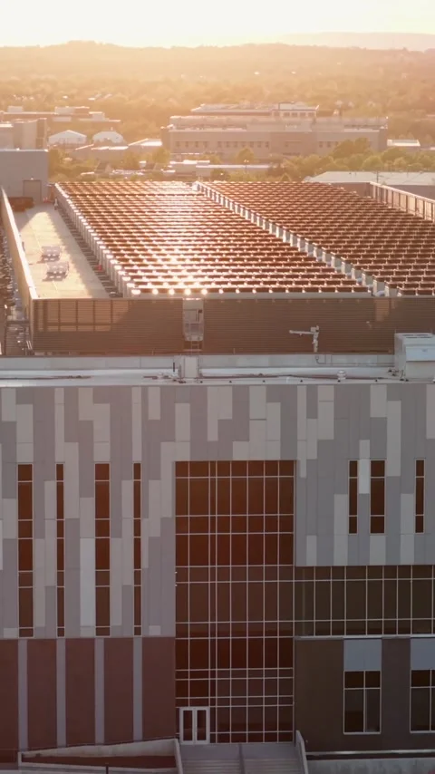 Warm sunset light climbs a data center facade in Ashburn, Virginia, revealing a Stock Footage 345728252
