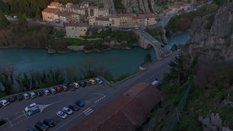 Warm sunset light over Rocher de la Baume and rooftops of Sisteron Stock Footage 307316804