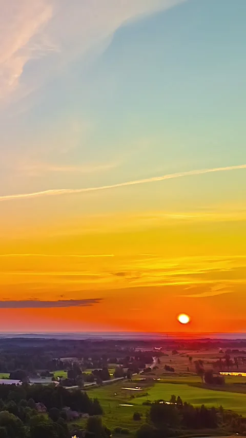 Warm Sunset Over Rolling Countryside with Open Sky Stock Footage 328996450