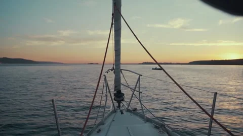 Warm sunset rays on water from luxury deck of sail yacht during in ocean Stock Footage 135378284