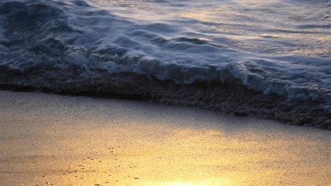 A warm sunset shines off waves on sandy beach, Maui, Hawaii. Stock Footage 107328896