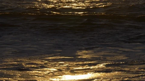 A warm sunset shines off waves on sandy beach, Kaanapali Coast, Maui, Hawaii Video stock 107329725