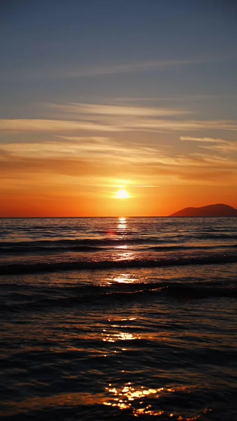 Warm Sunset Waves with Island Horizon Stock Footage 331872342