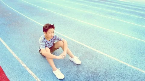 Warm tone Slow Boy give water to sitting boy 스톡 동영상 78740403