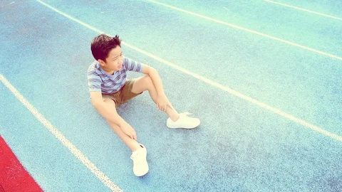 Warm tone Slow Boy give water to sitting boy 스톡 동영상 78740415