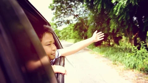 Warm tone Slow motion Boy in car waving hand  Stock Footage 79008190