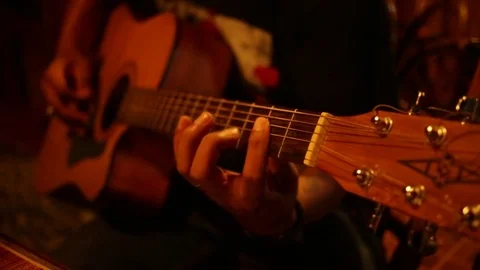 Warm toned, close up of man playing guitar at night time Stock Footage 71833261