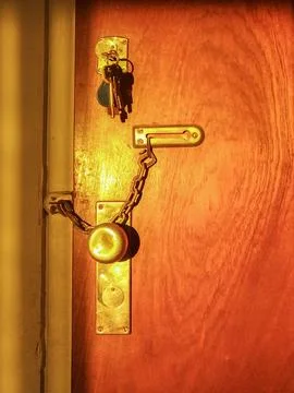 Warm toned door handle casting shadow Photos