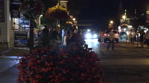 Warm ummer night with people walking and restaurant patios open post COVID 19 Stock Footage 158470598